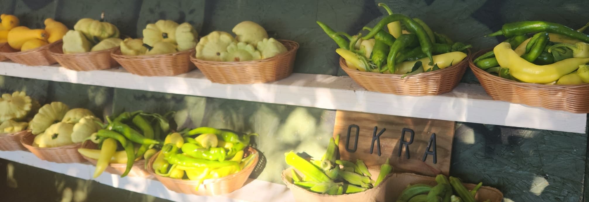 Peppers, squash, tomatoes, and other produce at the farm cart